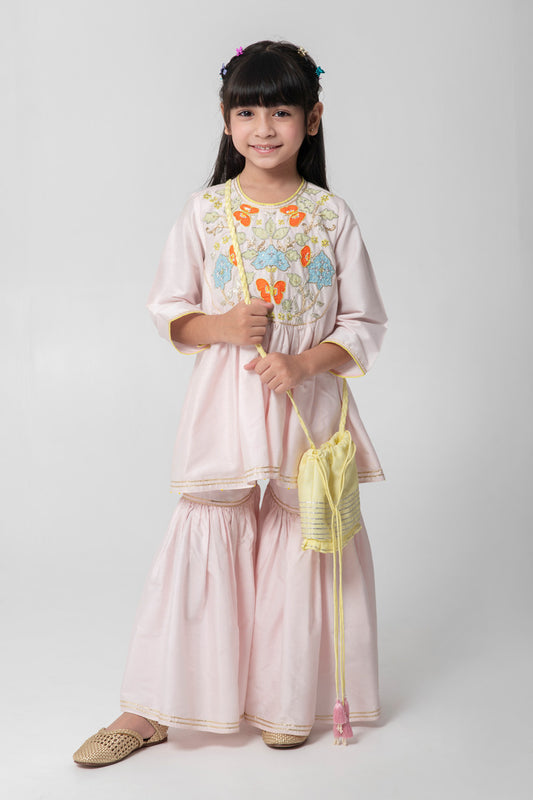 Pastel pink sharara with patchwork intricate embroidery. Cute neon potli added