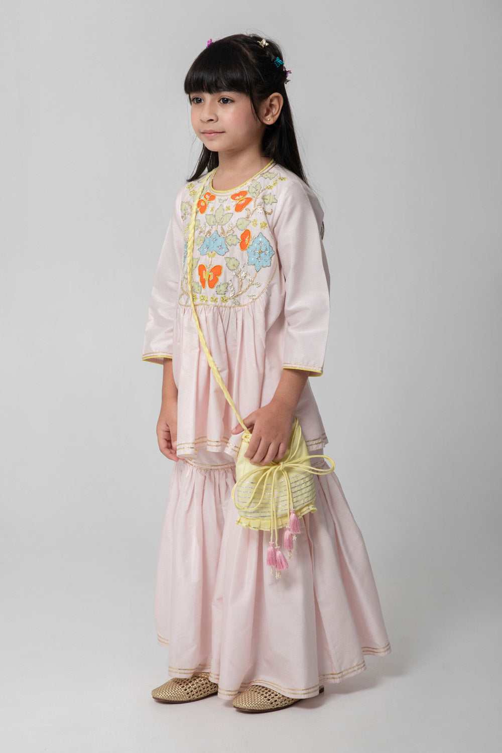 Pastel pink sharara with patchwork intricate embroidery. Cute neon potli added
