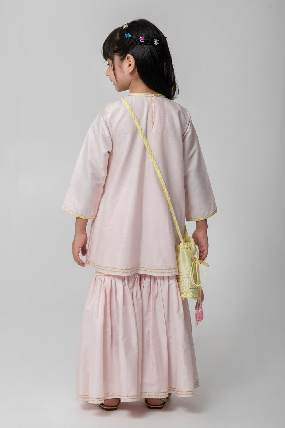 Pastel pink sharara with patchwork intricate embroidery. Cute neon potli added