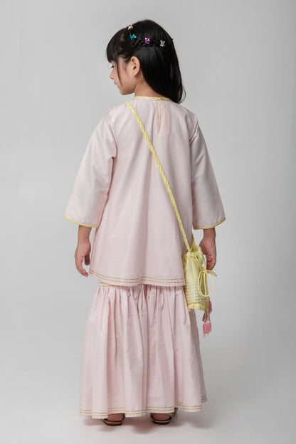 Pastel pink sharara with patchwork intricate embroidery. Cute neon potli added