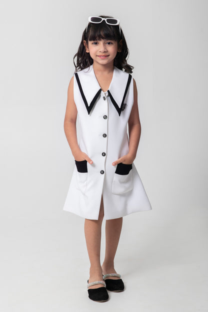 Black and white formal blazer dresses with embellished buttons and brooch.