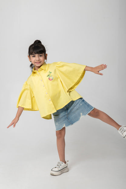 Yellow shirt with pear embroidered.