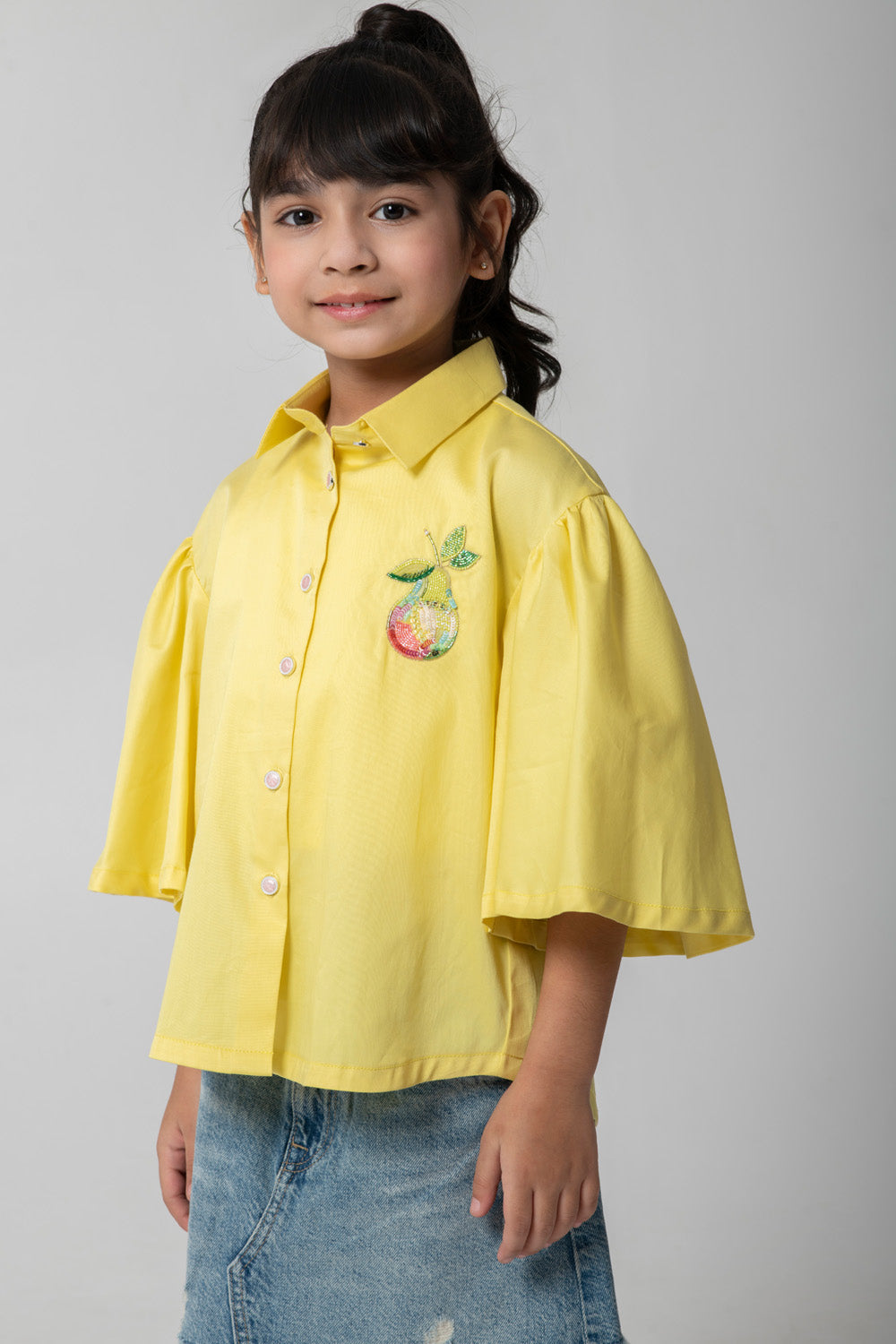 Yellow shirt with pear embroidered.