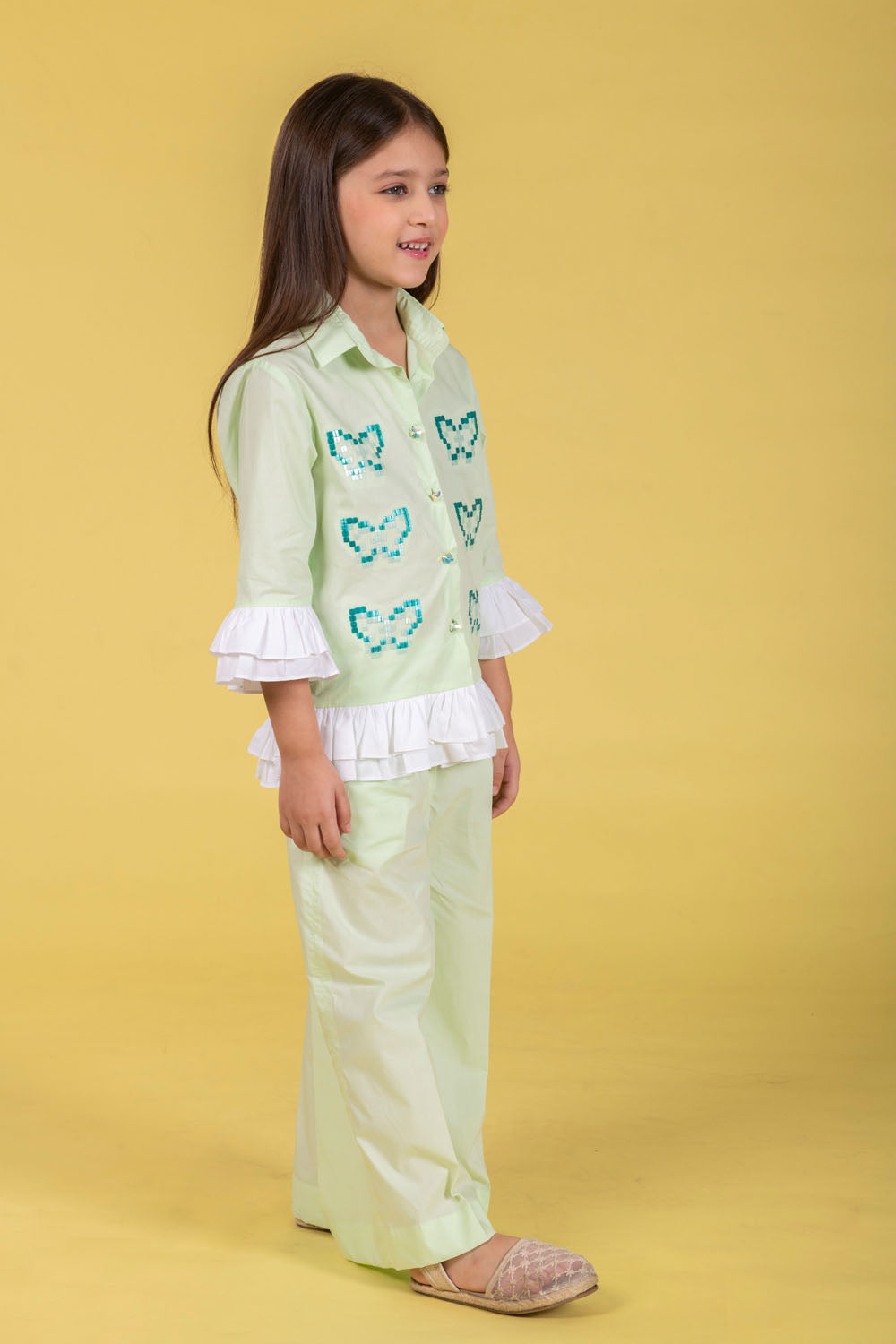 A MINT CO-ORD SET FEATURING A BUTTERFLY-EMBROIDERED SHIRT AND MATCHING WIDE-LEG PANTS.