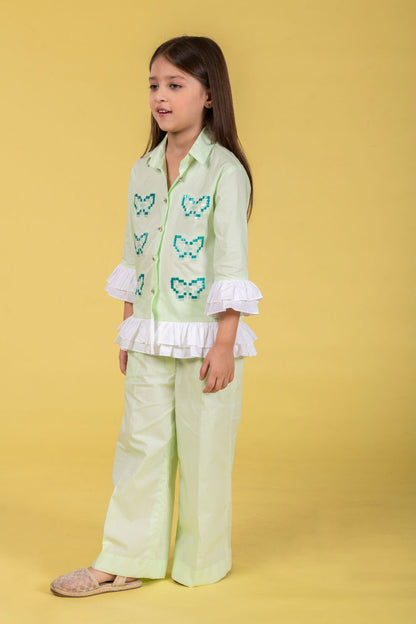 A MINT CO-ORD SET FEATURING A BUTTERFLY-EMBROIDERED SHIRT AND MATCHING WIDE-LEG PANTS.