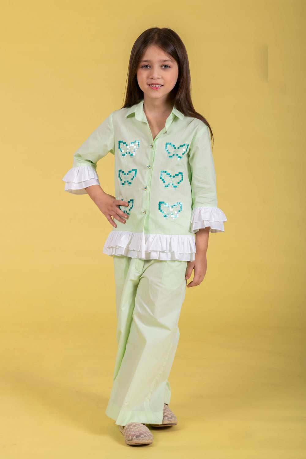 A MINT CO-ORD SET FEATURING A BUTTERFLY-EMBROIDERED SHIRT AND MATCHING WIDE-LEG PANTS.