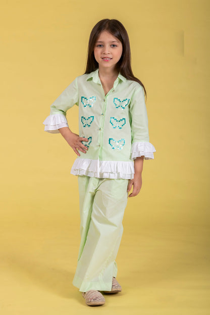 A MINT CO-ORD SET FEATURING A BUTTERFLY-EMBROIDERED SHIRT AND MATCHING WIDE-LEG PANTS.