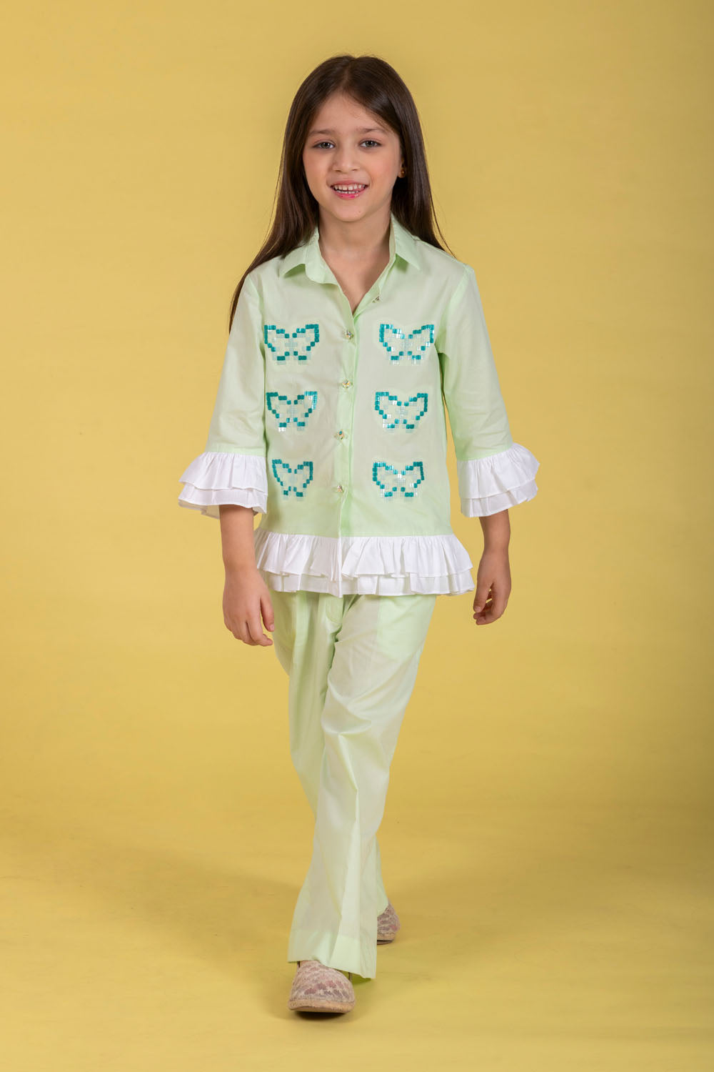 A MINT CO-ORD SET FEATURING A BUTTERFLY-EMBROIDERED SHIRT AND MATCHING WIDE-LEG PANTS.